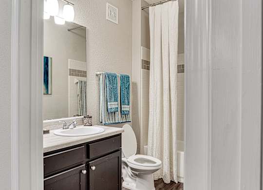 A white toilet sits next to a sink in a bathroom at Echo at Lake Norman, Mooresville