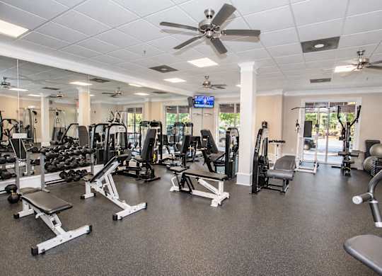 A spacious gym with a variety of equipment including treadmills, weights, and exercise machines.