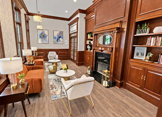 A living room with a fireplace and a chair.