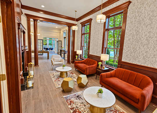A living room with a red couch and a white coffee table.