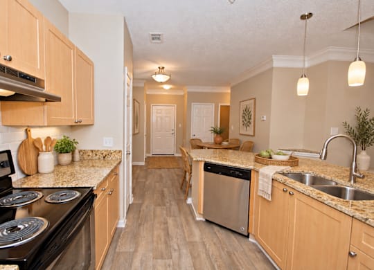 A kitchen with wooden cabinets and a black stove top oven.