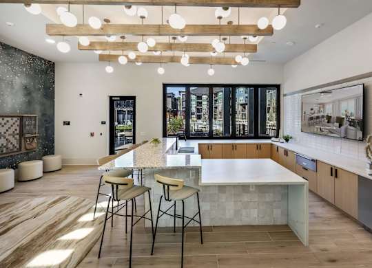 A modern kitchen with a large island and bar stools.