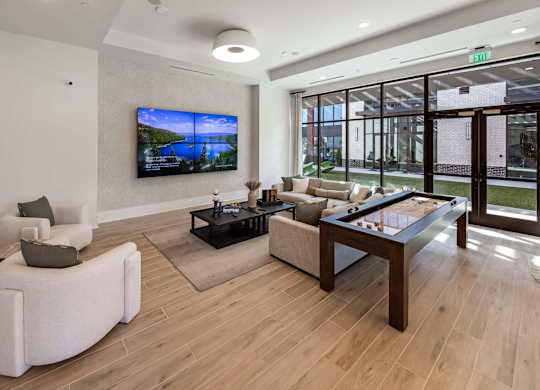 A modern living room with a flat screen TV mounted on the wall.