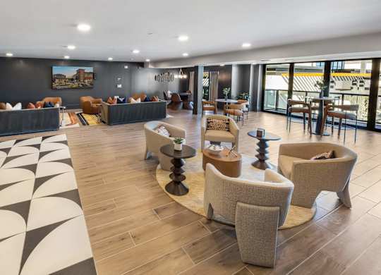 A spacious living room with a patterned rug and modern furniture.
