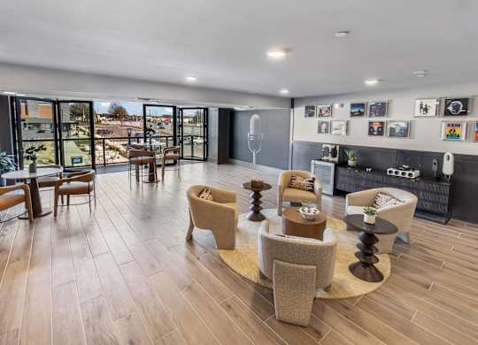 A living room with a wooden floor and a large window.