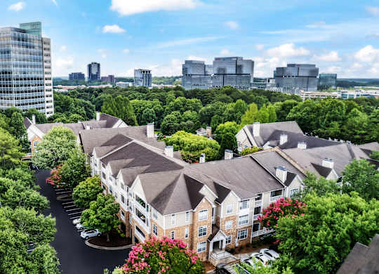 A view of a residential area with apartment buildings and trees.