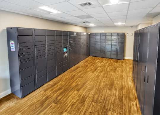 A room with wooden floors and black storage units.