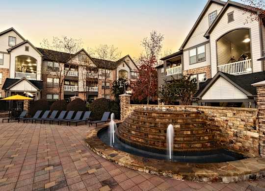 A large brick wall with a fountain in the middle of it.