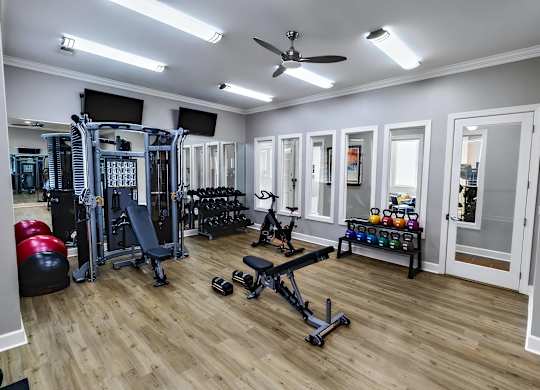 A well-equipped home gym with a variety of exercise equipment.