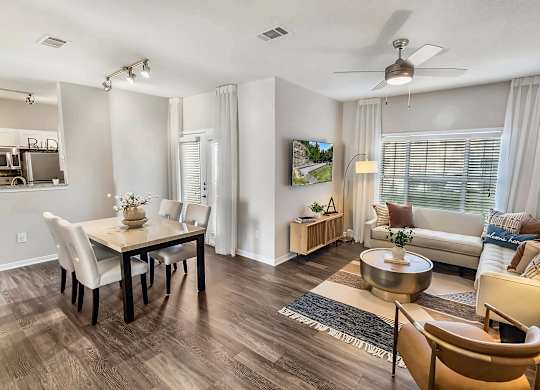 A living room with a dining table and chairs.