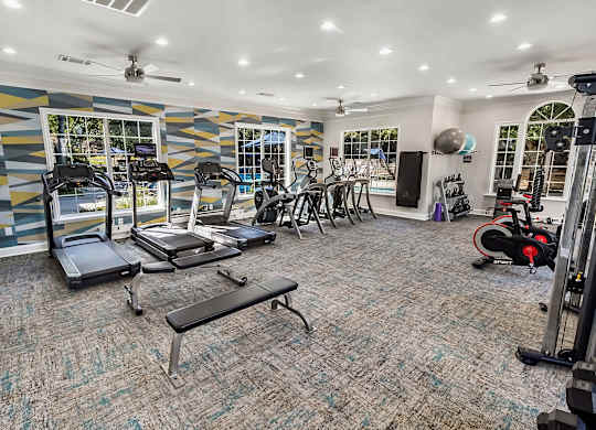A spacious home gym with a variety of exercise equipment.