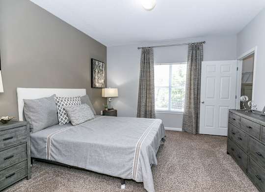 Bedroom With Expansive Windows at Villas at Hampton, Hampton