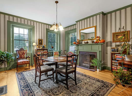 a dining room with a table and chairs and a fireplace