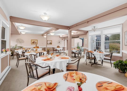 a dining room with tables and chairs and windows