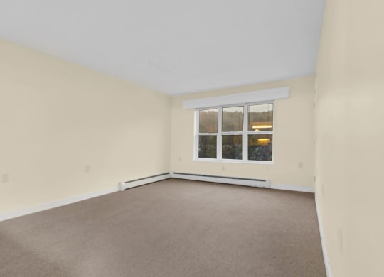 the living room of an empty house with a window
