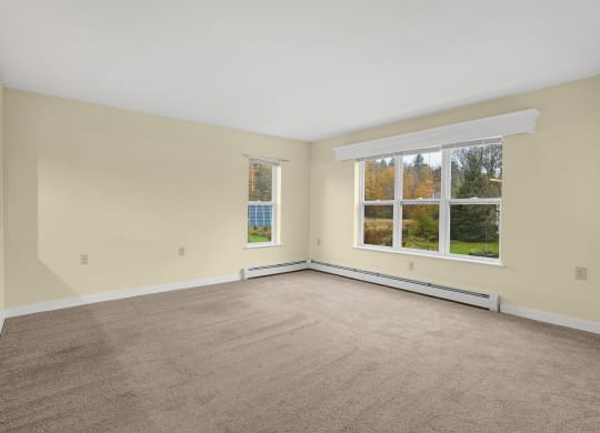the living room of an empty house with a large window