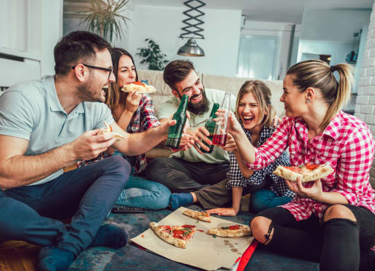friends having pizza and drinks