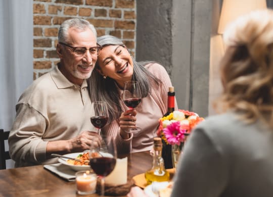 older couple laughing at dinner