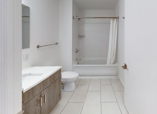 A bathroom with a white toilet, sink, and bathtub.