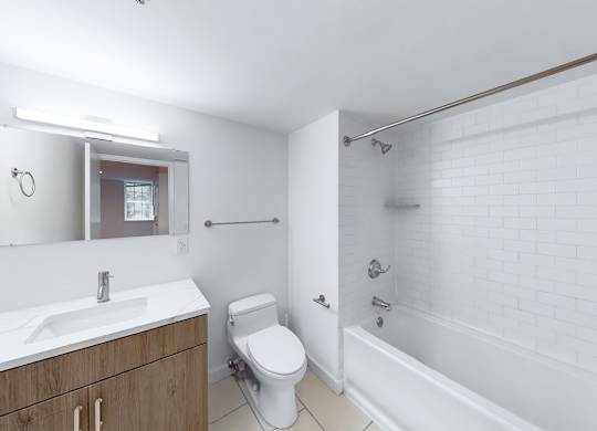 A white bathroom with a toilet, sink, and bathtub.