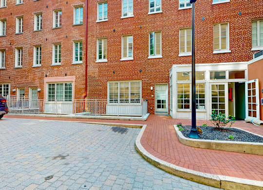 A red brick building with a small garden in front.