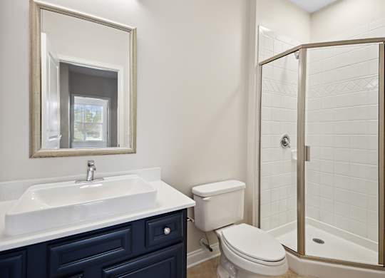 A bathroom with a white sink and a toilet.