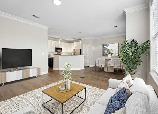 A living room with a white couch and a wooden coffee table.