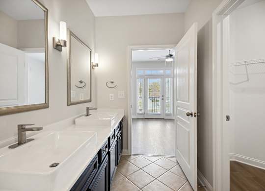 A bathroom with a white sink and a mirror.