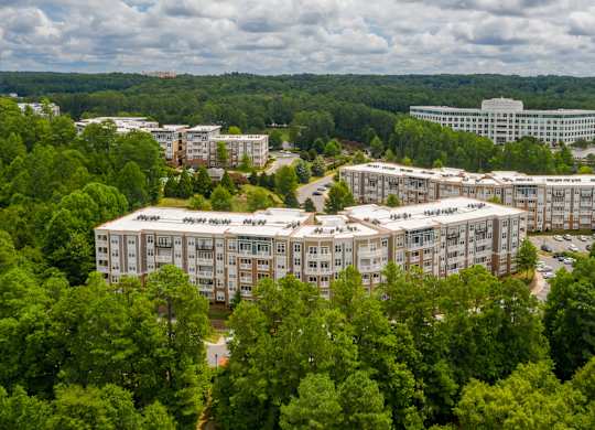 A large building complex surrounded by trees.