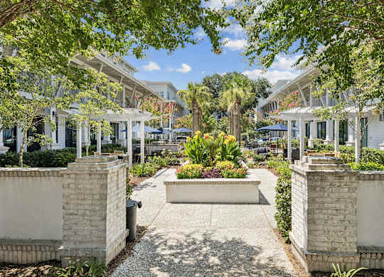 A sunny day at a residential area with a garden in the middle.
