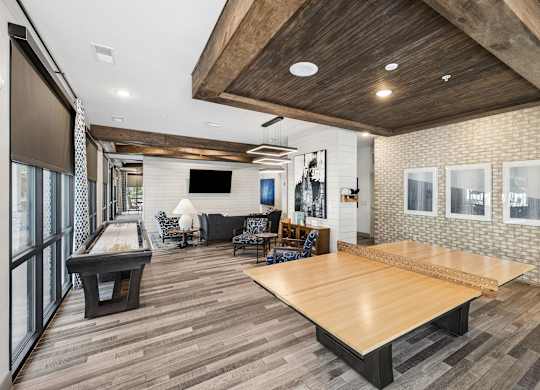 A room with a pool table and a shiny wooden floor.