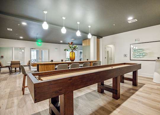 A room with a long table and chairs.