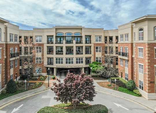 A large brick building with a tree in front of it.