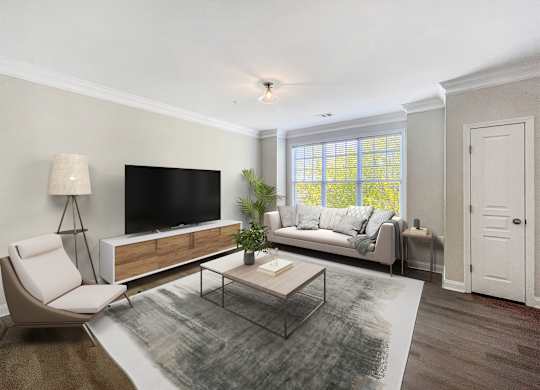 A modern living room with a white chair, a black television, and a glass coffee table.