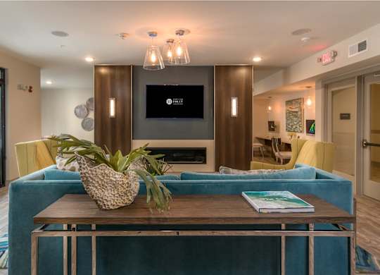 A living room with a blue couch and a wooden coffee table.