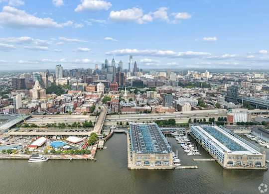 A cityscape with a large body of water in the foreground and a skyline in the background.