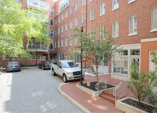 A white truck is parked in a courtyard.