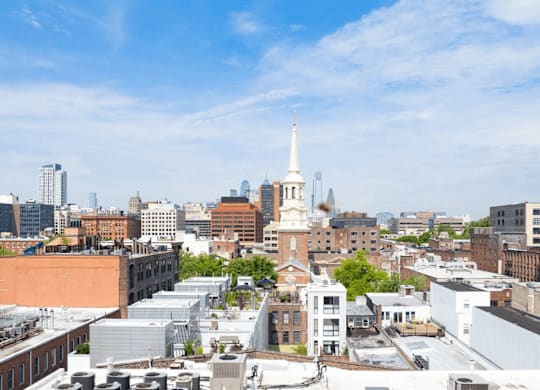 A cityscape with a prominent white tower in the center.