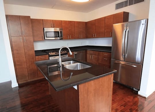 A kitchen with a sink and a refrigerator.