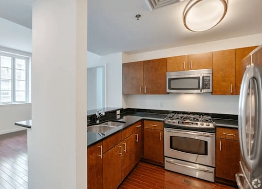 A kitchen with wooden cabinets and stainless steel appliances.