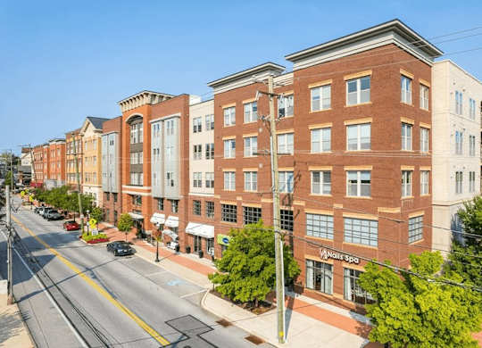 A street view of a city with a building that has a sign that says