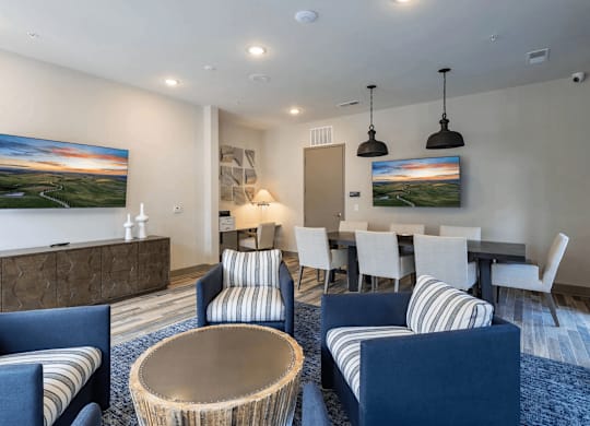 A modern living room with a dining table and chairs.