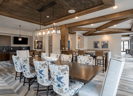 A large dining room with a long table surrounded by chairs.