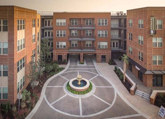 A courtyard with a fountain in the middle of it.