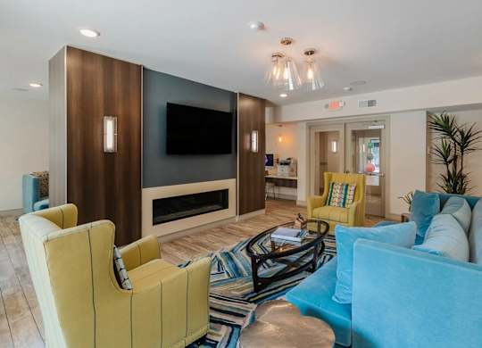 A living room with a yellow chair and a blue couch.
