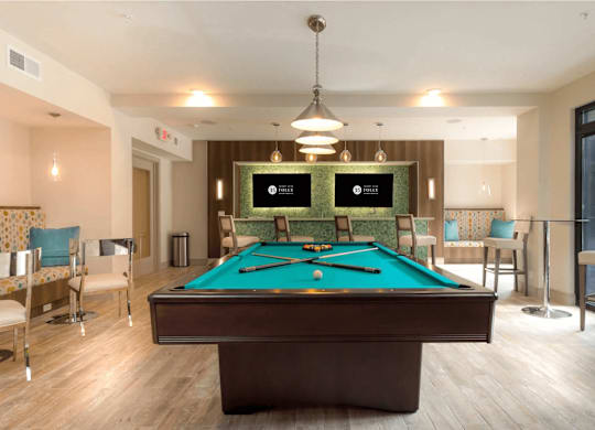 A pool table in a room with a light brown floor.