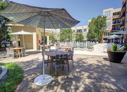 A patio with a table and chairs under a canopy.