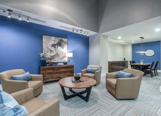 A living room with blue walls and furniture.
