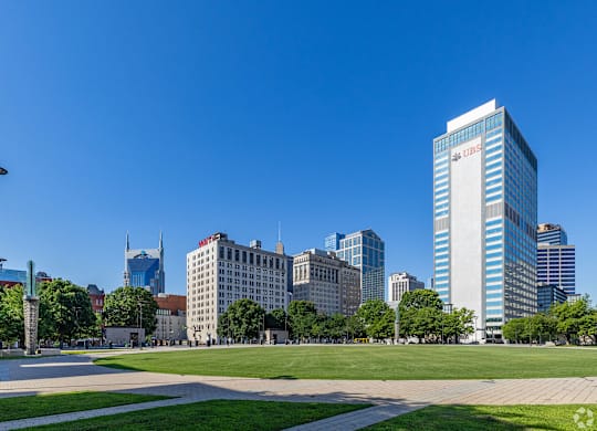 A cityscape with a tall building in the center.