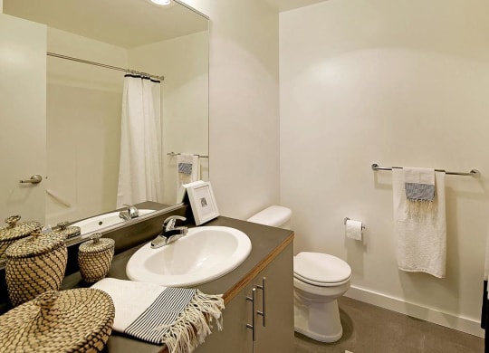 Bathroom with vanity and sink, toilet, and bath/shower combination.at 19th & Mercer, Seattle Washington